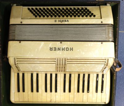 an old accordion sitting in a box on the floor