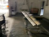 a long table in the middle of a room with lots of papers on it