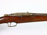 an old rifle with a wooden barrel and a metal handle
