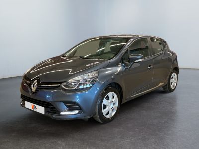 a grey car is parked in a room with a black floor
