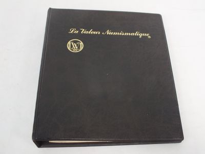 a black book with gold lettering on it sitting on a white surface