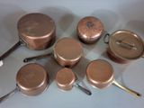 a lot of pots and pans that are sitting on a table