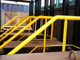 a yellow hand rail on the side of a building