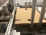 a picture of a machine that is making a cardboard box