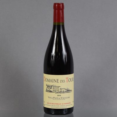 the bottle of red wine is sitting on a table