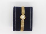 a close up of a watch on a velvet case