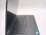 a laptop computer that is open on a white surface