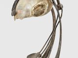an image of a sculpture of a bird with a shell in its beak
