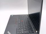 a black laptop with a red button on the keyboard