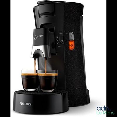 a black coffee maker with two cups of coffee next to it