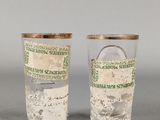 two shot glasses sitting next to each other on top of a table