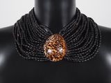 a close up of a mannequin wearing a leopard print necklace