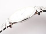 a close up of a wrist watch on a white surface