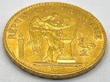an image of a gold coin with a statue on it