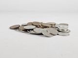 a pile of coins sitting on a white surface