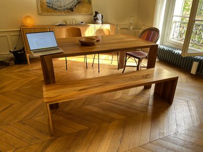 a wooden table with a laptop on it in a room