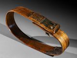 a close up of a wooden bracelet with a metal clasp