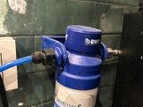 a water filtrator attached to a wall in a bathroom