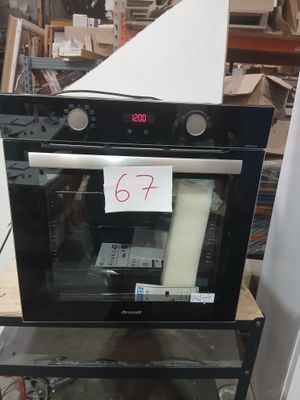 a black oven sitting on top of a table in a store