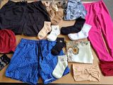 many different types of clothing laid out on a table