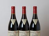 three bottles of wine sitting on top of a wooden table