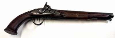 an old gun that is on display on a white surface