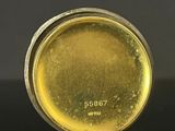 a close up picture of a gold plated object on a black surface