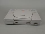a white game console sitting on top of a table