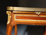 a small wooden table with a drawer on top of it
