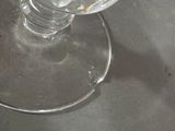a glass of water sitting on a table with a spoon in it