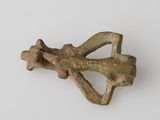 an image of a small bronze object on a white surface