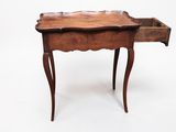 an old wooden table with a drawer on top of it