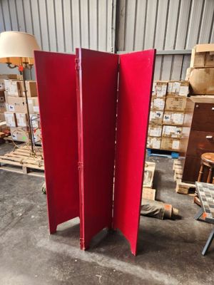 a red room divider in the middle of a warehouse