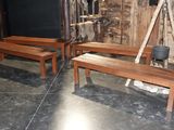 two wooden benches sitting next to each other in a room
