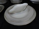 a black table with white plates and silverware on it