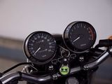 a close up of a motorcycle with a speedometer and gauges on the handlebars