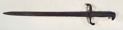 a very old sword hanging on the wall