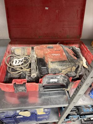 a red tool box with tools in it on a shelf