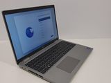 a laptop computer sitting on a table with a blue screen
