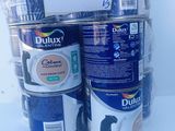 several cans of paint are stacked on top of each other