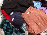 a basket full of clothes that is sitting on the floor