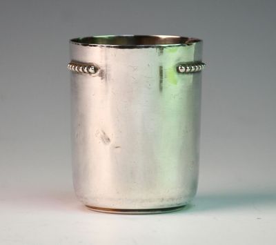 a silver cup that is sitting on a table