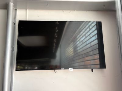 a flat screen tv mounted on a wall in a room