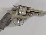 a small gun that is on a white surface