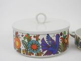 a white bowl with a lid and a colorful bowl with a bird on it