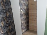 a mirror in the corner of a room with a wallpaper on the wall