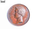 une image d'une pièce de monnaie sur laquelle figure le visage d'une femme
