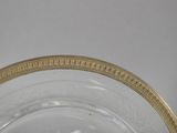 a glass bowl with a gold rim sitting on a table