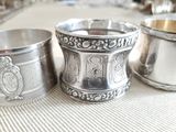 three silver cups sitting on a table next to each other