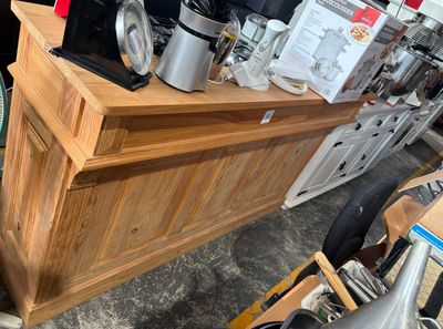 a wooden counter with a coffee maker on top of it